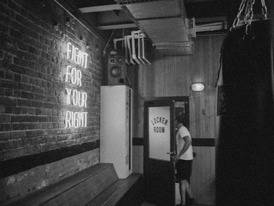 Modern minimalist gym interior with dark walls and neon